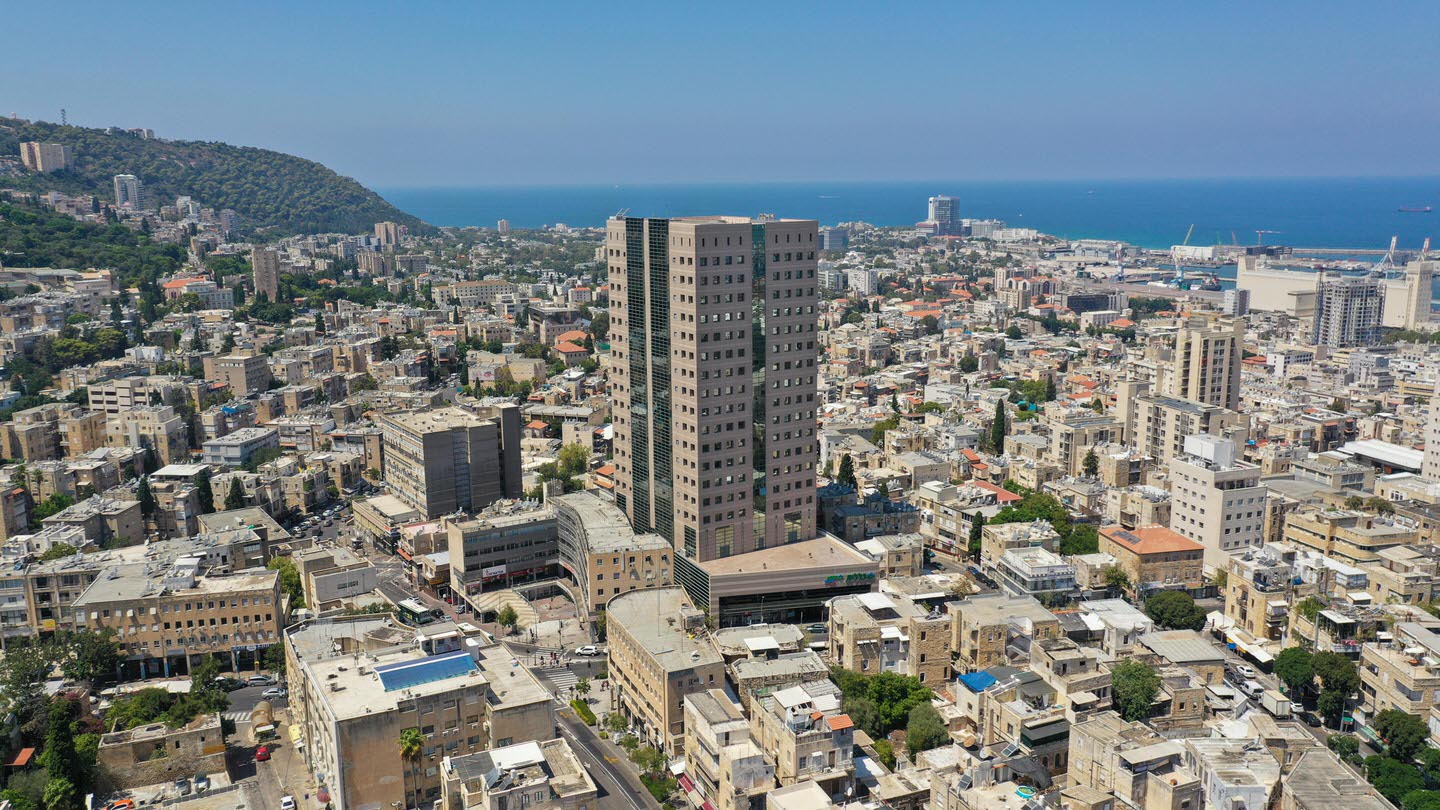 Migdal Armon: An aerial view of the fully-leased office and retail building strategically located on the main traffic artery between Haifa’s downtown and the Carmel area | Reality the Leading Group of Real Estate Investment Funds in Israel